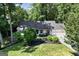 Stunning home exterior with beautiful landscaping, a three-car garage, and a charming front entrance at 591 Clubwood Ct, Marietta, GA 30068