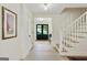 Bright hallway featuring hardwood floors, staircase and entry to the living spaces at 591 Clubwood Ct, Marietta, GA 30068
