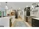 Bright kitchen with stainless steel appliances, a large island, and an elegant brick accent wall at 591 Clubwood Ct, Marietta, GA 30068