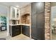 Charming kitchen area features custom cabinetry, brick detailing and modern stainless steel appliances at 591 Clubwood Ct, Marietta, GA 30068
