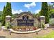 Stone sign marking the entrance to the Indian Hills Country Club with colorful flowers at 591 Clubwood Ct, Marietta, GA 30068
