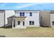 Exterior of white home featuring a well maintained backyard and covered porch at 4434 Eastbrook Pl # 59A, Snellville, GA 30039