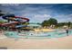 Lenora Park pool with winding water slides and patrons enjoying a sunny day at 4434 Eastbrook Pl # 59A, Snellville, GA 30039