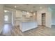 Bright kitchen features a center island, granite countertops, white cabinets and stainless steel appliances at 4434 Eastbrook Pl # 59A, Snellville, GA 30039
