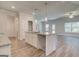 Kitchen island with granite countertops and stainless steel faucet, open to living space at 4434 Eastbrook Pl # 59A, Snellville, GA 30039