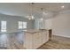 Bright kitchen with island, granite countertops, modern light fixtures, and stainless steel faucet at 4434 Eastbrook Pl # 59A, Snellville, GA 30039