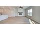 Bright open-concept living area with wood floors, fireplace, and plenty of natural light at 4434 Eastbrook Pl # 59A, Snellville, GA 30039