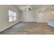 Open living space with wood flooring, a ceiling fan, and large windows for natural light at 4434 Eastbrook Pl # 59A, Snellville, GA 30039