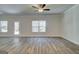 Open-concept living area with wood flooring, a ceiling fan, and natural light at 4434 Eastbrook Pl # 59A, Snellville, GA 30039