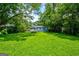 Expansive backyard featuring a lush green lawn, mature trees, and a cozy house at 1821 Clearwater, Marietta, GA 30067