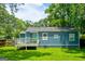 Backyard showcasing a blue house, a wooden deck, and a spacious grassy area at 1821 Clearwater, Marietta, GA 30067