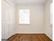 This bedroom features hardwood floors, white walls, a closet, and a window at 1821 Clearwater, Marietta, GA 30067