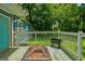 Wooden deck featuring a fire pit and a clear view of the lush backyard and blue house at 1821 Clearwater, Marietta, GA 30067