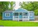 Charming blue cottage-style home with a welcoming front porch and lush green lawn at 1821 Clearwater, Marietta, GA 30067
