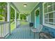 Charming front porch with seating, a vibrant blue painted floor, and white railing at 1821 Clearwater, Marietta, GA 30067