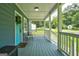 Inviting front porch with blue painted floor, white railing, and vibrant turquoise door at 1821 Clearwater, Marietta, GA 30067