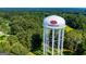 Aerial view of a water tower surrounded by lush green trees at 508 College St, Bowdon, GA 30108
