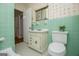 Charming bathroom with retro tile, a classic sink vanity, and unique wallpaper, offering vintage appeal at 508 College St, Bowdon, GA 30108