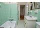Retro bathroom featuring a classic bathtub, vintage tiles, and sink, showcasing a unique charm at 508 College St, Bowdon, GA 30108