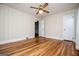 Bedroom featuring hardwood floors, neutral walls, and a ceiling fan for added comfort at 508 College St, Bowdon, GA 30108