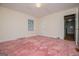 Bedroom featuring pink carpeting, a window, and neutral walls at 508 College St, Bowdon, GA 30108