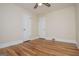 This bedroom features hardwood floors, neutral walls, a ceiling fan, and two doors at 508 College St, Bowdon, GA 30108