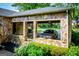 Carport constructed from stone with landscaping in the foreground and stone staircase leading up at 508 College St, Bowdon, GA 30108