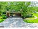 Spacious carport featuring stone accents, a parked vehicle, and well-manicured lawn at 508 College St, Bowdon, GA 30108