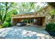 Carport with two spaces and stone accents and a silver sedan parked inside at 508 College St, Bowdon, GA 30108