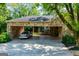Stone carport with a car parked under it, offering shaded parking at 508 College St, Bowdon, GA 30108