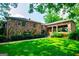 Unique stone-clad home with open carport and lush green lawn at 508 College St, Bowdon, GA 30108