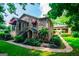 Charming stone home with well-manicured lawn, complemented by an open carport at 508 College St, Bowdon, GA 30108