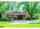 Stone home with a covered parking area showing the driveway, front yard and side of the house at 508 College St, Bowdon, GA 30108
