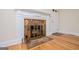 Close up of a living room fireplace with hardwood flooring and a decorative fireplace screen at 508 College St, Bowdon, GA 30108