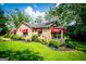 Charming stone home with red awnings, mature trees, and beautiful yard in a desirable neighborhood at 508 College St, Bowdon, GA 30108