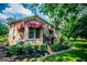 Charming stone home with red awnings, mature trees and side entrance offers nice views and curb appeal at 508 College St, Bowdon, GA 30108