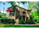 Charming stone home with red awnings and steps leading to quaint lower entry door in nice area at 508 College St, Bowdon, GA 30108