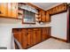 A view of the kitchen featuring wood cabinets, white countertops, and stainless-steel appliances at 508 College St, Bowdon, GA 30108