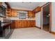 View of kitchen featuring stainless-steel appliances, wood cabinets, countertops and lots of natural light at 508 College St, Bowdon, GA 30108