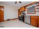 A kitchen area featuring stainless-steel appliances, wood cabinets, and lots of natural light at 508 College St, Bowdon, GA 30108
