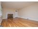Spacious living room with hardwood floors, neutral paint, and a cozy fireplace at 508 College St, Bowdon, GA 30108