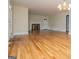 Living room with hardwood flooring, fireplace, neutral paint, and white trim throughout at 508 College St, Bowdon, GA 30108