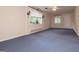 Spacious living room featuring large windows and carpet flooring, ideal for comfortable living at 508 College St, Bowdon, GA 30108