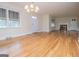 Bright living room featuring hardwood floors, neutral paint, a fireplace, and an elegant chandelier at 508 College St, Bowdon, GA 30108