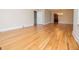 Bright open living area with beautiful hardwood floors leading to the kitchen at 508 College St, Bowdon, GA 30108