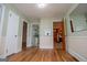 Open room showcasing hardwood flooring, neutral paint, and multiple doorways leading to different areas at 508 College St, Bowdon, GA 30108