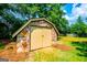 A stone shed sits in the backyard with a door for convenient storage at 508 College St, Bowdon, GA 30108