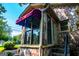 Cozy stone sunroom featuring large windows, awning, and easy access to outdoors at 508 College St, Bowdon, GA 30108