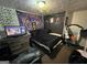 Cozy bedroom featuring a dark aesthetic, wall decorations, and a comfortable bed setup at 3929 Rockey Valley Dr, Conley, GA 30288