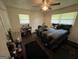 Bright bedroom with natural light, featuring a ceiling fan, a keyboard, and a comfortable bed at 3929 Rockey Valley Dr, Conley, GA 30288